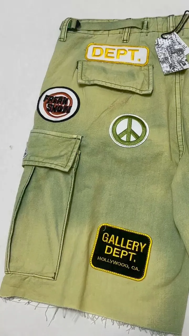GALLERY DEPT. KENZIE FATIGUE CARGO SHORTS Patch embroidered shorts, distressed ink-splashed overalls, olive green size 30/32/34/36, heavy wash garment dyeing, jetted horse fade, washed and distressed products, each piece is slightly different, each piece is a work of art, Shimada machine embroidery, hand-splashed ink graffiti
